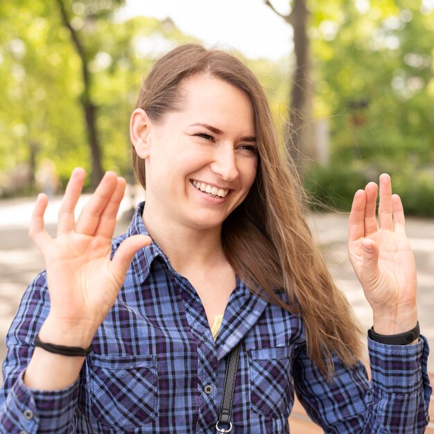 Portrait of smiley woman communicating through sign language