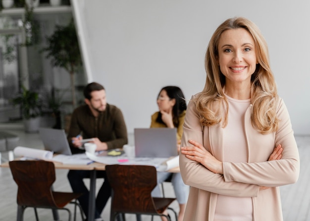 portrait of smiley woman posing next to her colleagues