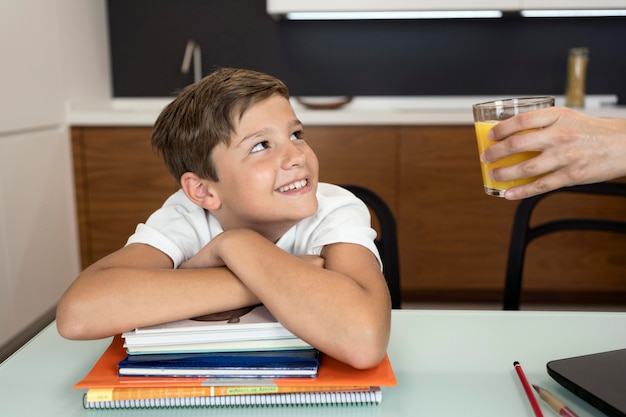 Free photo portrait of smiley young boy looking at his mother