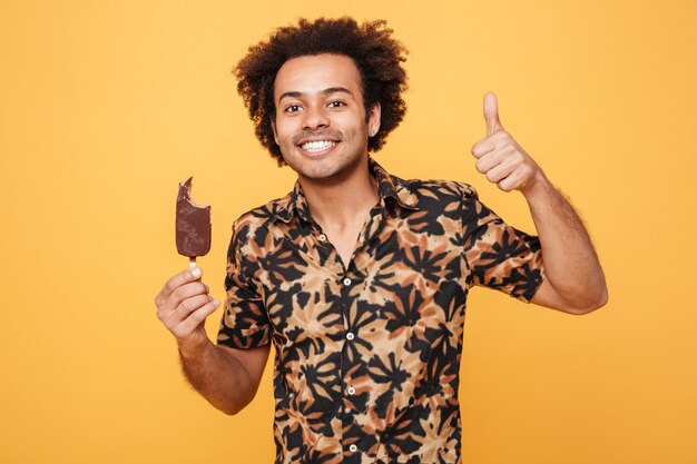 Portrait of a smiling afro american man holding ice cream