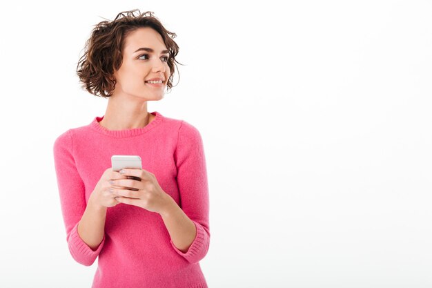 Portrait of a smiling attractive girl holding mobile phone