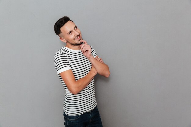 Portrait of a smiling attractive man thinking