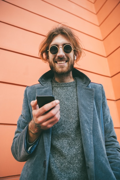 Portrait of a smiling bearded man in coat