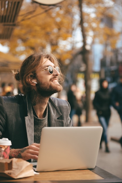 Portrait of a smiling bearded man in earphones