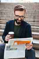 Free photo portrait of a smiling bearded man sitting