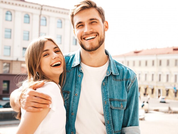 Portrait of smiling beautiful girl and her handsome boyfriend. Woman in casual summer jeans clothes.  