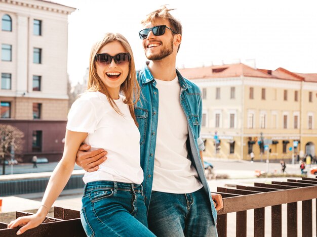 Portrait of smiling beautiful girl and her handsome boyfriend. Woman in casual summer jeans clothes.   