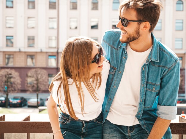 Portrait of smiling beautiful girl and her handsome boyfriend. Woman in casual summer jeans clothes.   