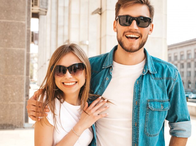 Portrait of smiling beautiful girl and her handsome boyfriend. Woman in casual summer jeans clothes.   