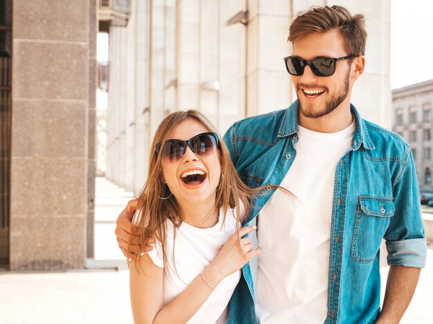 Portrait of smiling beautiful girl and her handsome boyfriend. Woman in casual summer jeans clothes.   