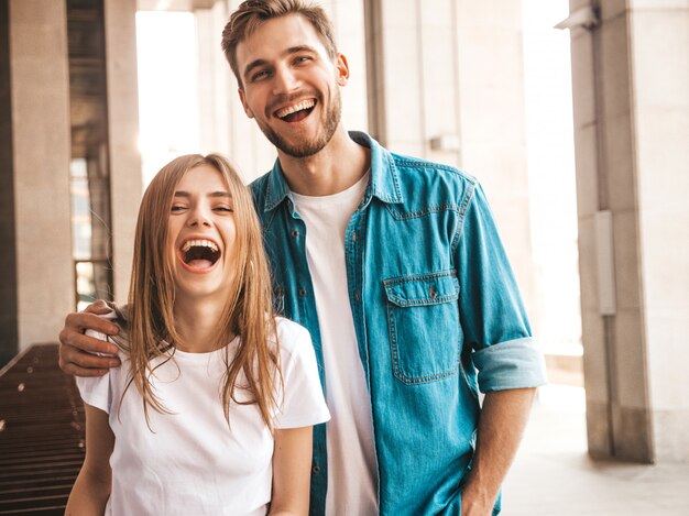 Portrait of smiling beautiful girl and her handsome boyfriend. Woman in casual summer jeans clothes.  