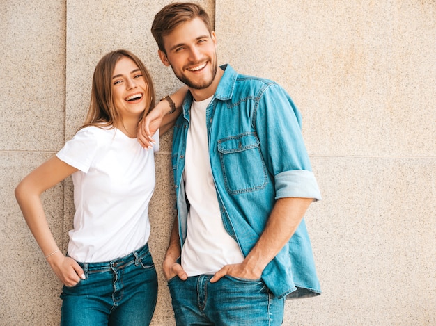 Portrait of smiling beautiful girl and her handsome boyfriend. Woman in casual summer jeans clothes.  