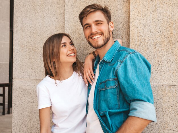 Portrait of smiling beautiful girl and her handsome boyfriend. Woman in casual summer jeans clothes.  