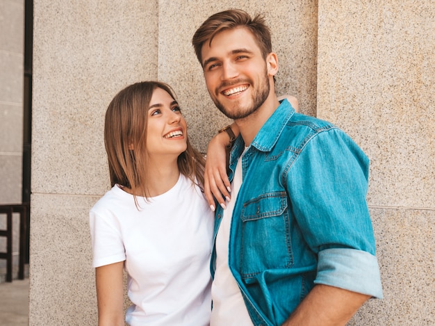 Portrait of smiling beautiful girl and her handsome boyfriend. Woman in casual summer jeans clothes.  