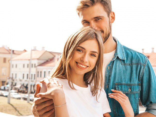 Portrait of smiling beautiful girl and her handsome boyfriend. Woman in casual summer jeans clothes.  