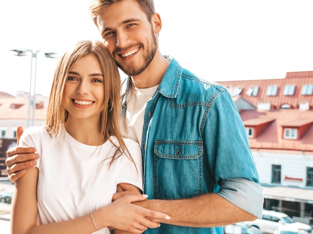 Portrait of smiling beautiful girl and her handsome boyfriend. Woman in casual summer jeans clothes.  