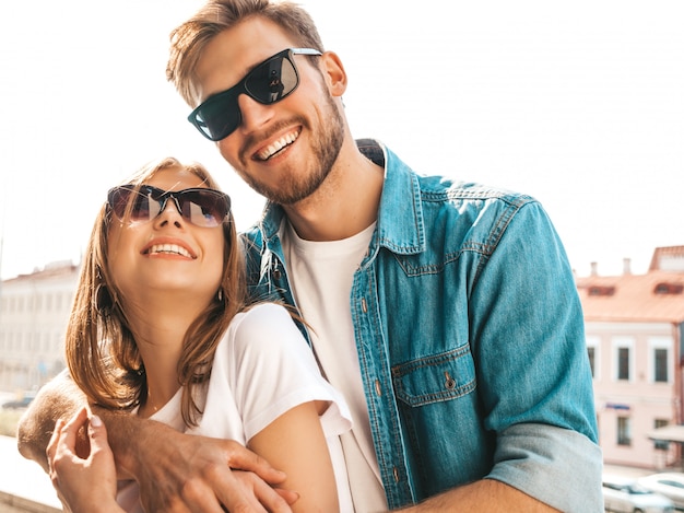 Portrait of smiling beautiful girl and her handsome boyfriend. Woman in casual summer jeans clothes.    