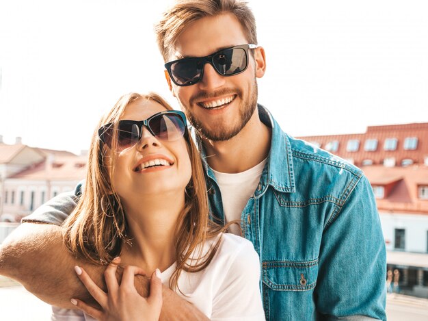 Portrait of smiling beautiful girl and her handsome boyfriend. Woman in casual summer jeans clothes.    
