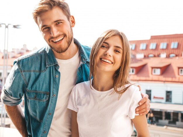 Portrait of smiling beautiful girl and her handsome boyfriend. Woman in casual summer jeans clothes. 