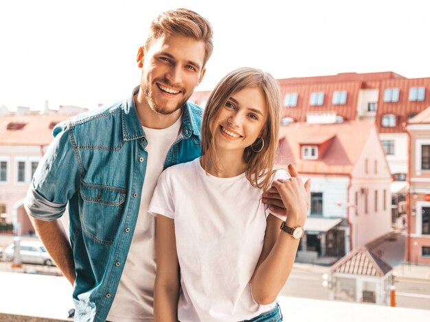 Portrait of smiling beautiful girl and her handsome boyfriend. Woman in casual summer jeans clothes.  