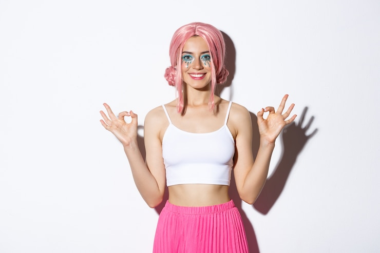 Free Photo portrait of smiling beautiful girl with pink anime wig and bright makeup