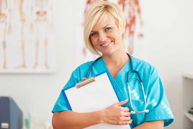 Portrait of smiling blonde female surgeon