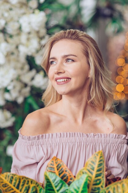 Portrait of smiling blonde young woman looking away