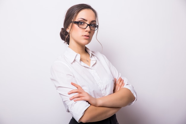 Portrait of smiling business woman, isolated on white wall