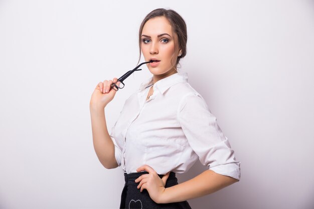 Portrait of smiling business woman, isolated on white wall