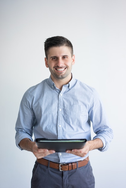 Portrait of smiling businessman holding folder with documents.