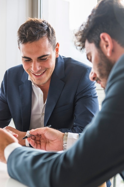 Portrait of smiling businessman sitting with his partner