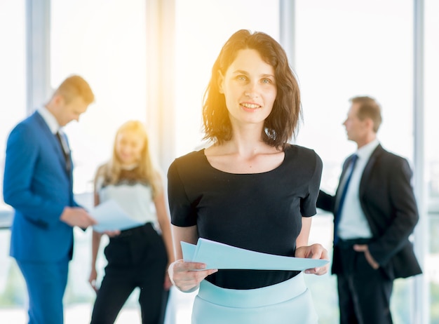 Portrait of a smiling businesswoman with documents