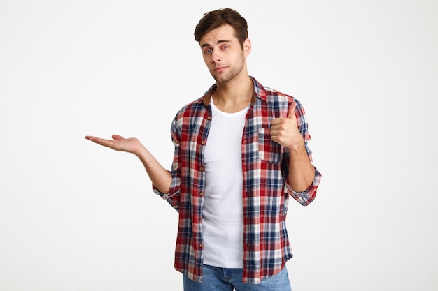 Portrait of a smiling casual man holding copy space