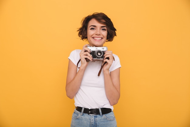 Free photo portrait of a smiling cute woman retro camera