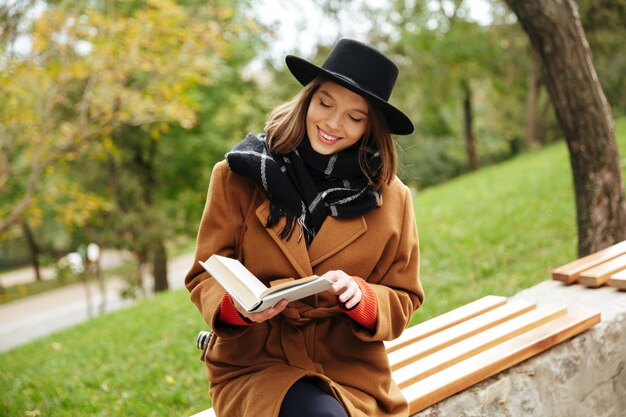 Portrait of a smiling girl dressed in autumn clothes