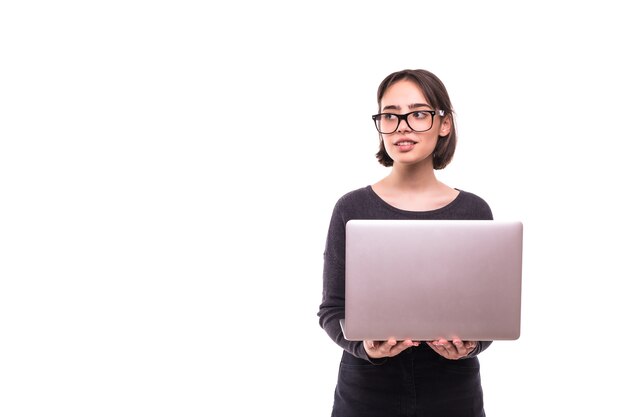 Portrait of a smiling girl holding laptop computer isolated