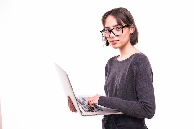 Portrait of a smiling girl holding laptop computer isolated