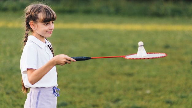 Portrait of a smiling girl playing with badminton