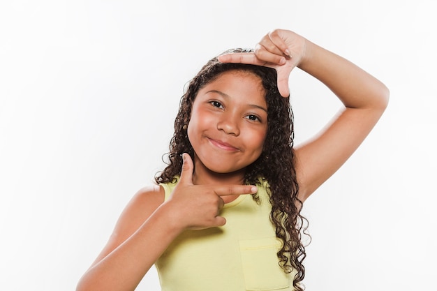 Portrait of a smiling girl on white backdrop