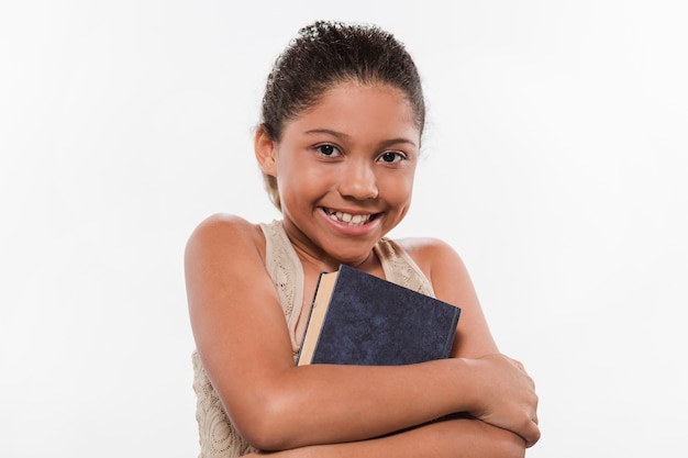 Free photo portrait of a smiling girl with book on white background