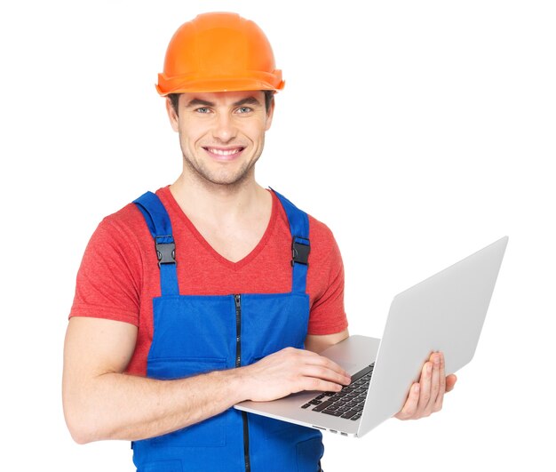 Portrait of smiling handyman with laptop isolated on white