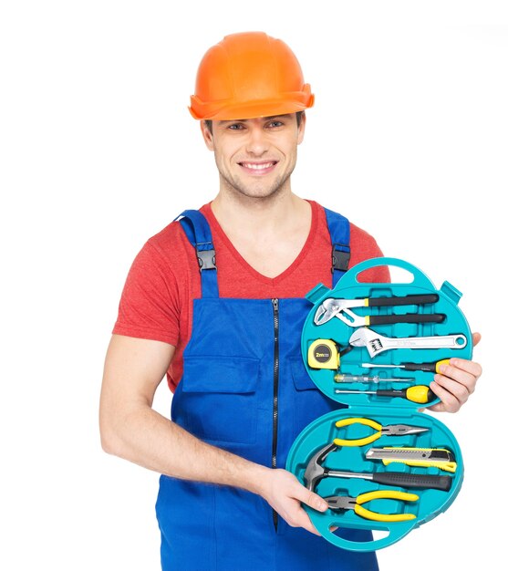 Portrait of smiling handyman with tools isolated on white