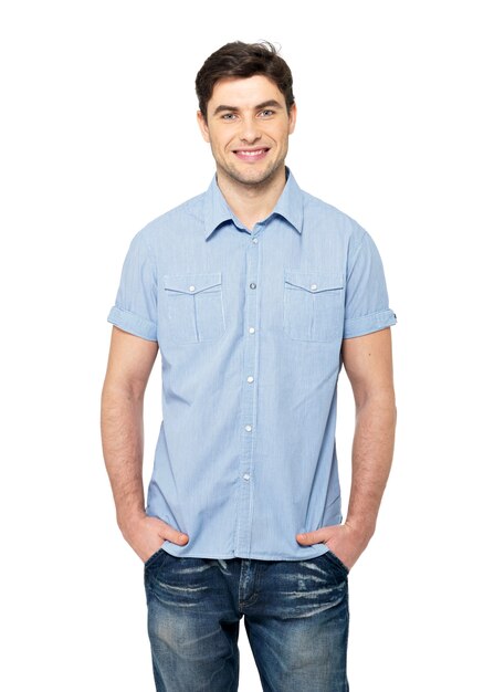 Portrait of smiling happy handsome man in blue casual shirt - isolated on white wall