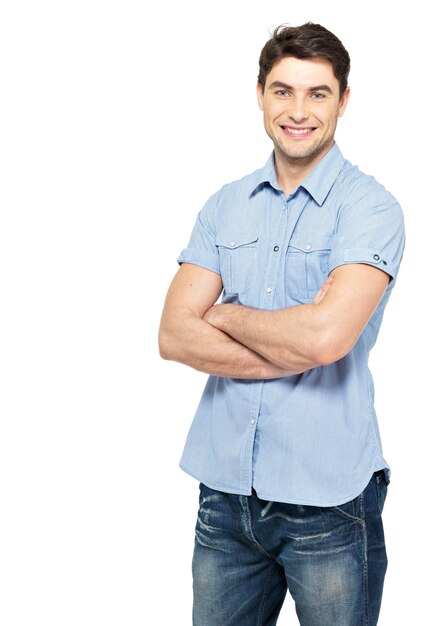 Portrait of smiling happy handsome man in blue casual shirt - isolated on white wall