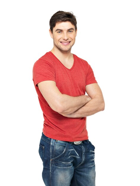 Portrait of smiling happy handsome man in casuals red t-shirt - isolated on white wall