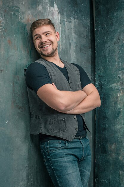 Portrait of smiling happy man standing in studio