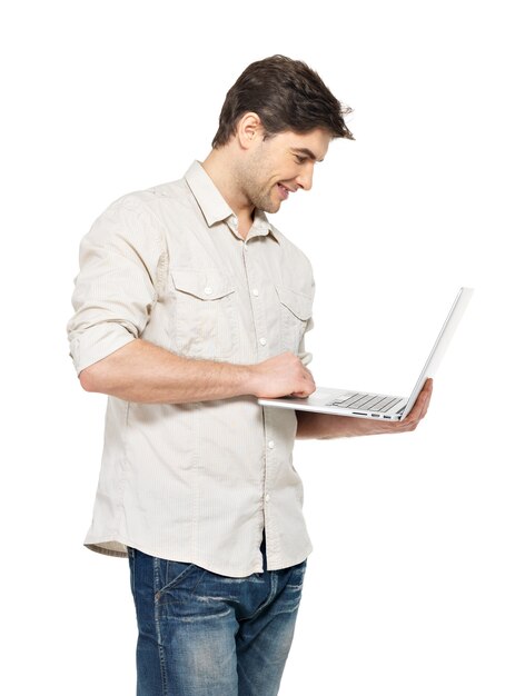 Portrait of smiling happy man with laptop  in casuals - isolated on white. Concept communication.
