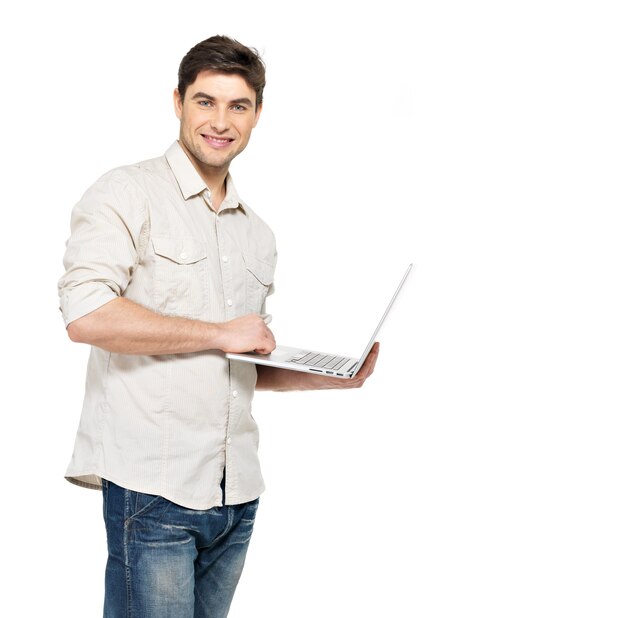 Portrait of smiling happy man with laptop  in casuals - isolated on white. Concept communication.