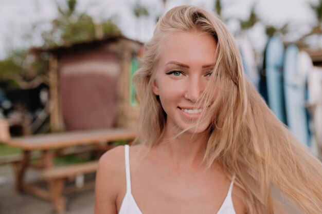 Portrait of smiling happy woman with long flying hair and adorable smile