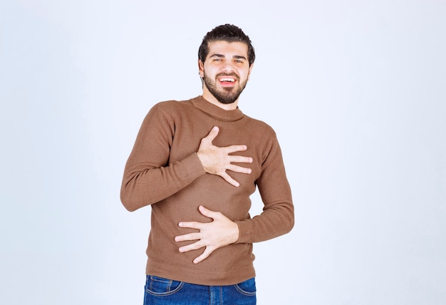 Portrait of a smiling man model standing and laughing